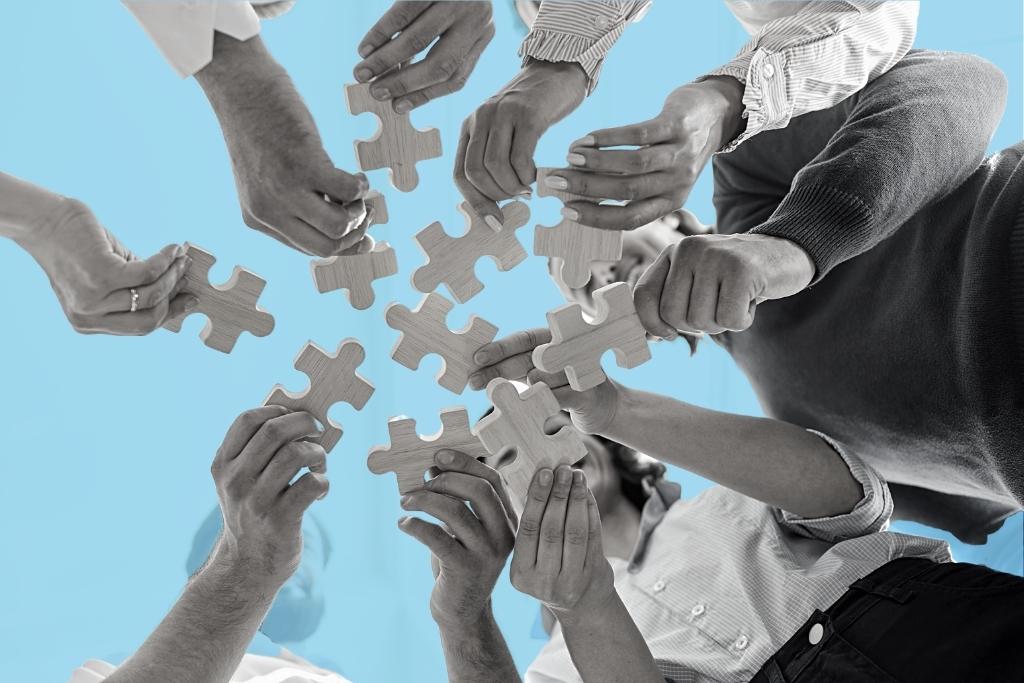 People holding puzzle parts