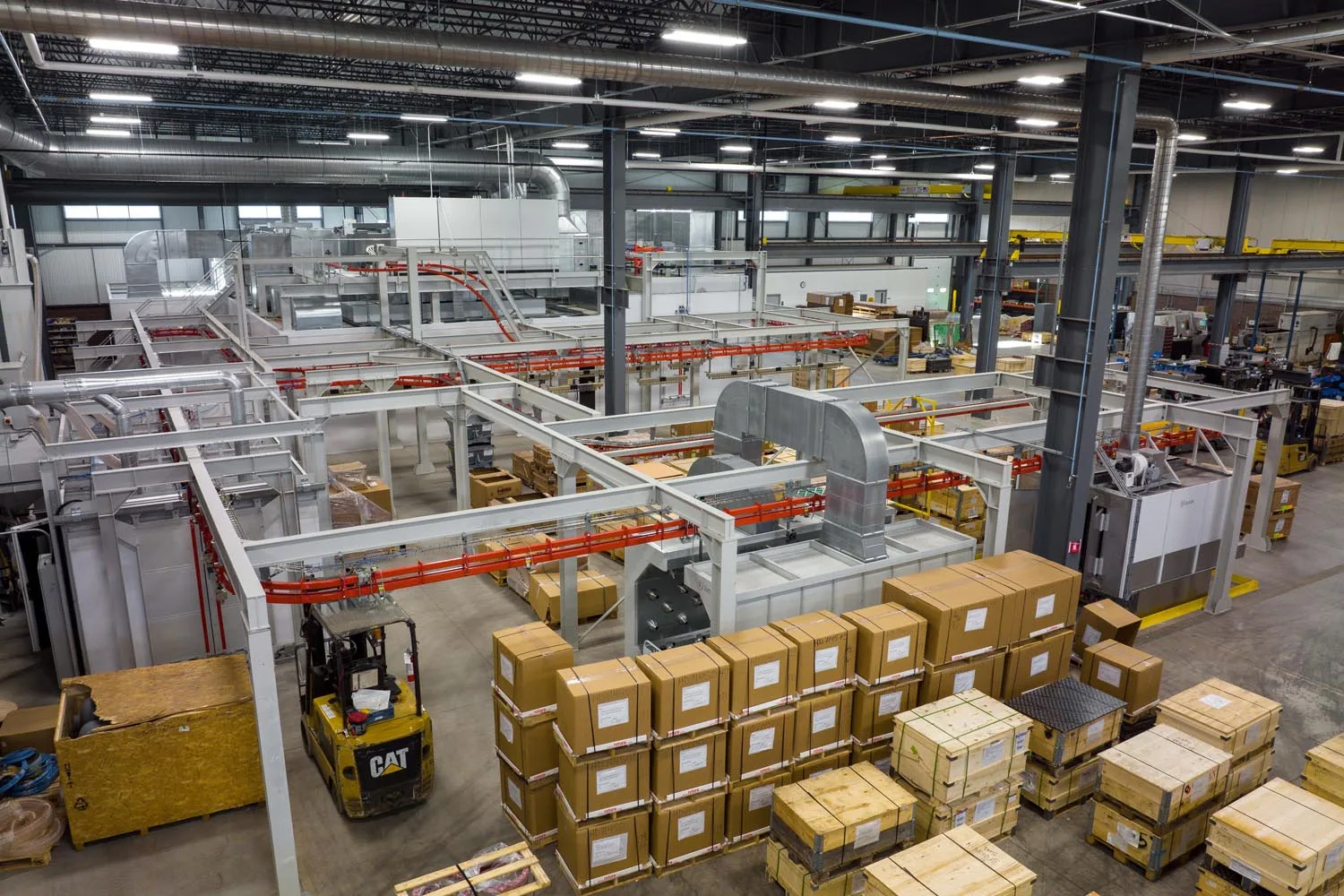 Interior view of Rotork’s Bath manufacturing facility showing assembly lines, material handling systems, and boxed components ready for distribution. The site produces electric actuators used in global flow control applications.